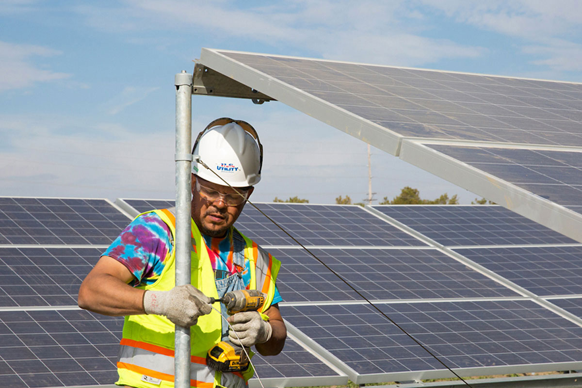 Male construction worker helping to build the University of Illinois Solar Farm.