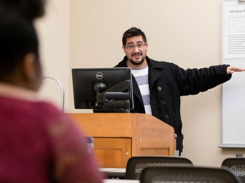 A male professor gives a presentation 