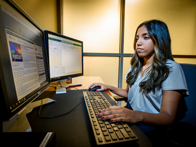 U of I student Sruthi Navneetha, part of SPOTLITE’s student research team, compiles data and scans news articles for police uses of lethal force. (Photo by Fred Zwicky.)